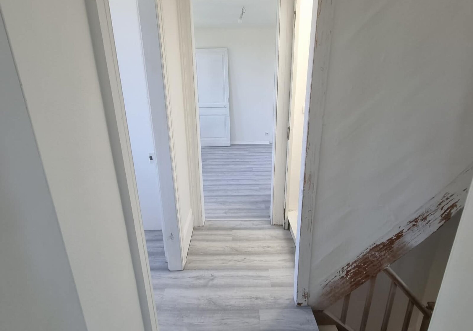 Couloir avec sol stratifié et peinture blanche. — artisan bâtiment Nord (59)